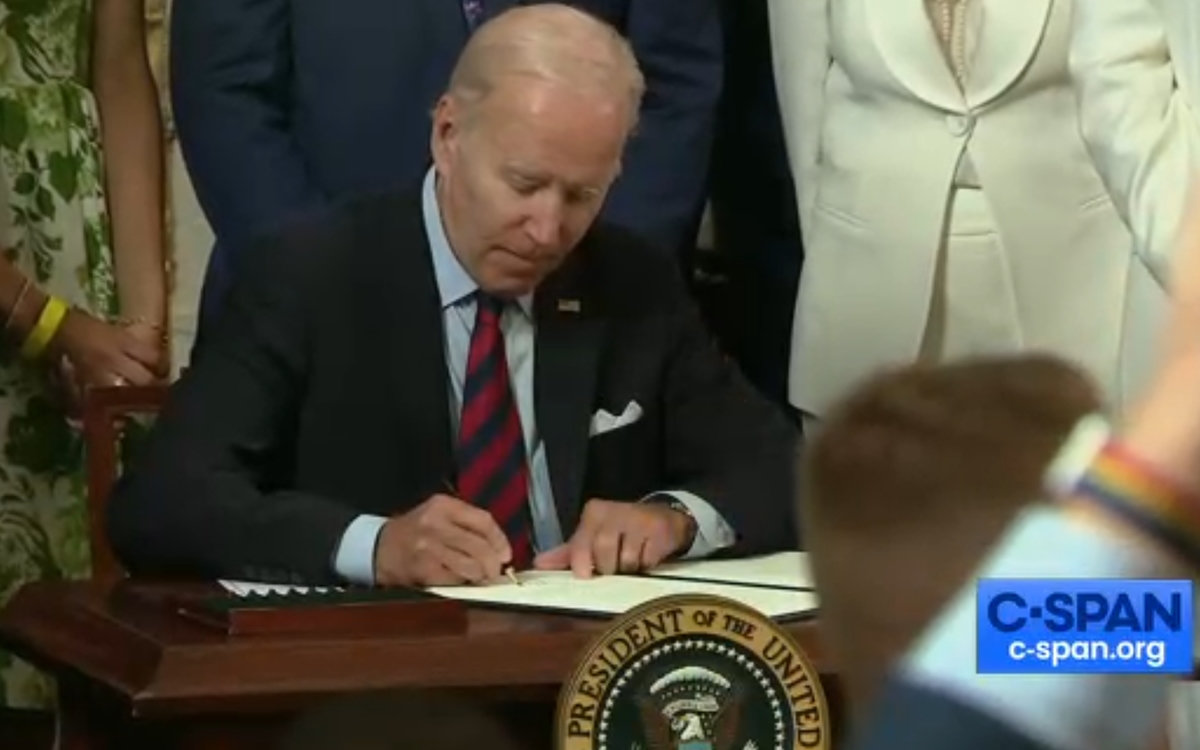 President Joe Biden signs an executive order that expands LGBTQ rights
