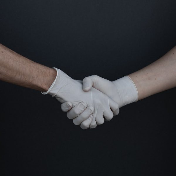 person holding white heart shaped paper