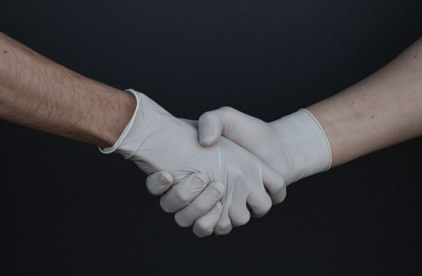 person holding white heart shaped paper